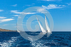 Unidentified sailboats participate in sailing regatta 12th Ellada Autumn 2014 among Greek island group in the Aegean Sea