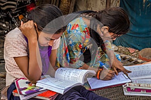 Unidentified school girls of Indian Ethnicity busy doing homework