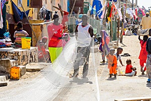 Unidentified Senegalese man holds a fishing net at the local ma