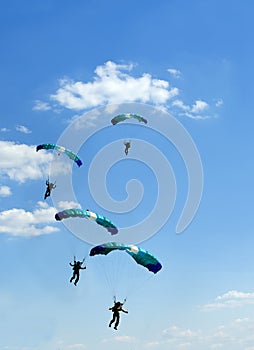 Unidentified skydiver on blue sky