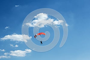 Unidentified skydiver on blue sky