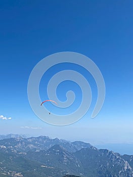 Unidentified skydiver, parachutist on blue sky