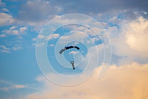 Unidentified skydiver, parachutist on blue sky