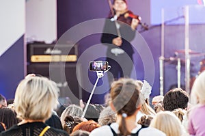 Unidentified spectator filming scene by mobile phone during a concert dedicated Moscow city day on September 9, 2019