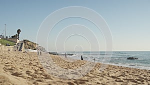 Unidentified surfer skimboarding on sea beach