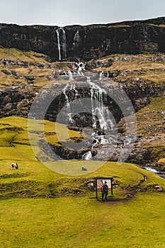 Unidentified tourist near a waterfall in Saksun