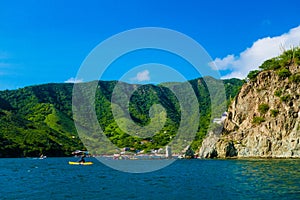 Unidentified tourists at the beautiful caribbean beach during a beautiful sunny day in Taganga, Colombia photo