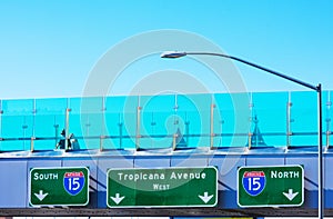 Unidentified tourists walking on pedestrian bridge over Tropicana Avenue and Las Vegas Boulevard intersection. Interstate 15