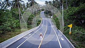 Unidentified woman walking on beautiful Road Khanom Sichon Road