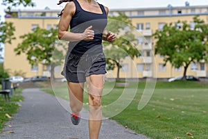 Unidentified woman wearing tank top and shorts