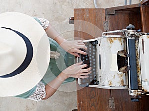 Unidentified womanâ€™s hand typing on retro typing machine