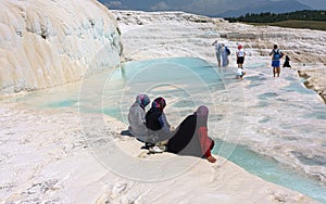 Unidentified women watch Pamukkale known with its travertine terraces and health-giving pools with mineral water. Turkey.