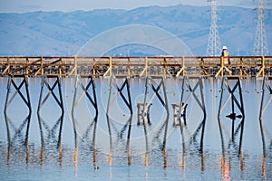 Unidentified worker walking on a raised wooden platform