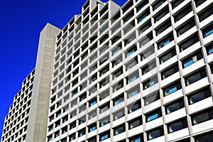 A uniform appartement building with uniformly colored curtains in the windows