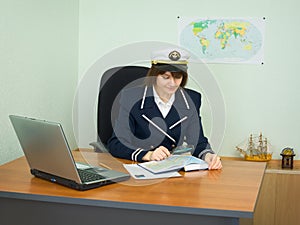 In uniform of captain examines geographical