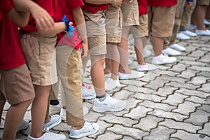 Uniformed children aligned legs