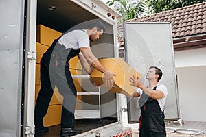 Uniformed employees carry out efficient unloading of cardboard boxes from the