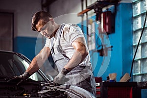 Uniformed mechanic in service station