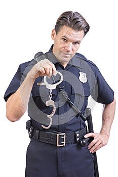 Uniformed police officer holding handcuffs