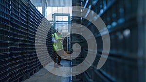 Uniformed warehouse worker checking boxes shipment counting blue packages