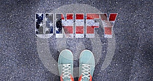 Unify and politics in the USA, symbolized as a person standing in front of the phrase Unify in American flag colors to show that