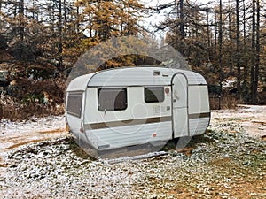 Uninhabited camper in the snowy wood. Piedmont, Val di Susa, Italy