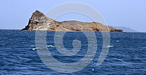 Uninhibited rocky volcanic islet near Hanish island in Red Sea photo