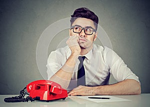 Uninspired corporate employee sitting in his office daydreaming photo