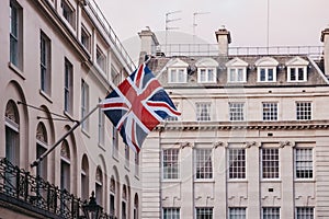 Union Jack British flag on a pole outside a building in London, UK