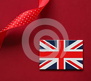 Union Jack flag of Great Britain  on red background, Queen's Platinum Jubilee and holiday celebration