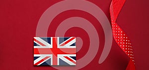 Union Jack flag of Great Britain  on red background, Queen's Platinum Jubilee and holiday celebration