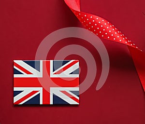 Union Jack flag of Great Britain  on red background, Queen's Platinum Jubilee and holiday celebration