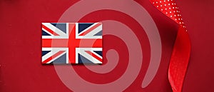 Union Jack flag of Great Britain  on red background, Queen's Platinum Jubilee and holiday celebration