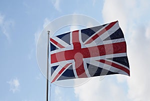 Union Jack flag of the United Kingdom over blue sky