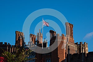 Union Jack flying over Hampton Court Palace in sunshine against