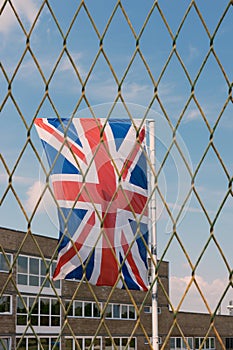 The Union Jack  the national flag of the United Kingdom behind the fence