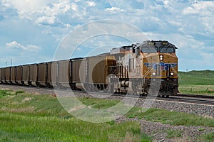 Union Pacific locomotive 8135 heads eastbound with a train with coal loaded hoppers with helper Union Pacific diesel locomotive