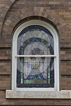 Unique arched stained glass window.