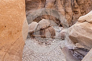 The unique beauty of high mountains on both sides of the dry stream in the gorge Wadi Al Ghuwayr or An Nakhil and the wadi Al