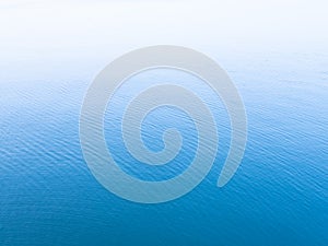 Unique blue background. Blue sea water surface texture background with white copy space on top