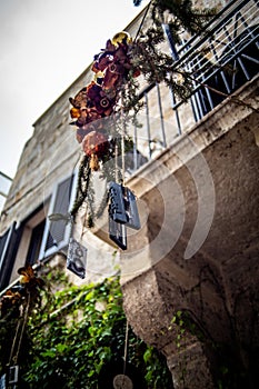 Unique Christmas Decoration: Cassette Tape Hanging from Christmas Branch in a Typical Polignano a Mare Street photo