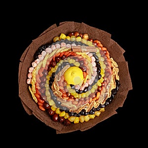 Unique colorful gift in the form of a bouquet of dried fruits isolated on black background