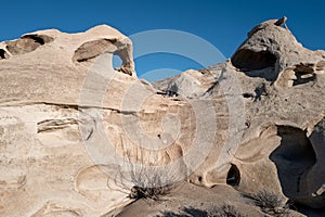 Unique eroded patters in rock with blue sky