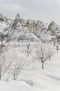 Unique geological rock formations under snow in Cappadocia, Turk