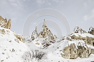 Unique geological rock formations under snow in Cappadocia, Turk