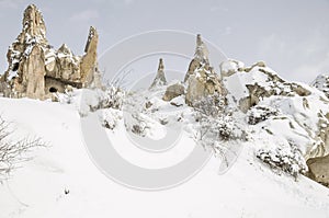 Unique geological rock formations under snow in Cappadocia, Turk