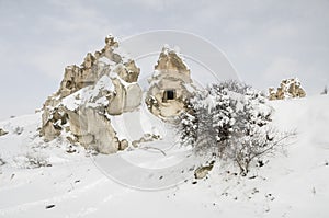 Unique geological rock formations under snow in Cappadocia, Turk