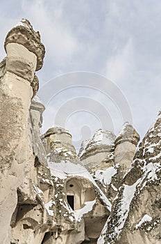 Unique geological rock formations under snow in Cappadocia, Turk