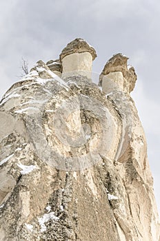 Unique geological rock formations under snow in Cappadocia, Turk