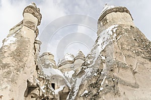 Unique geological rock formations under snow in Cappadocia, Turk